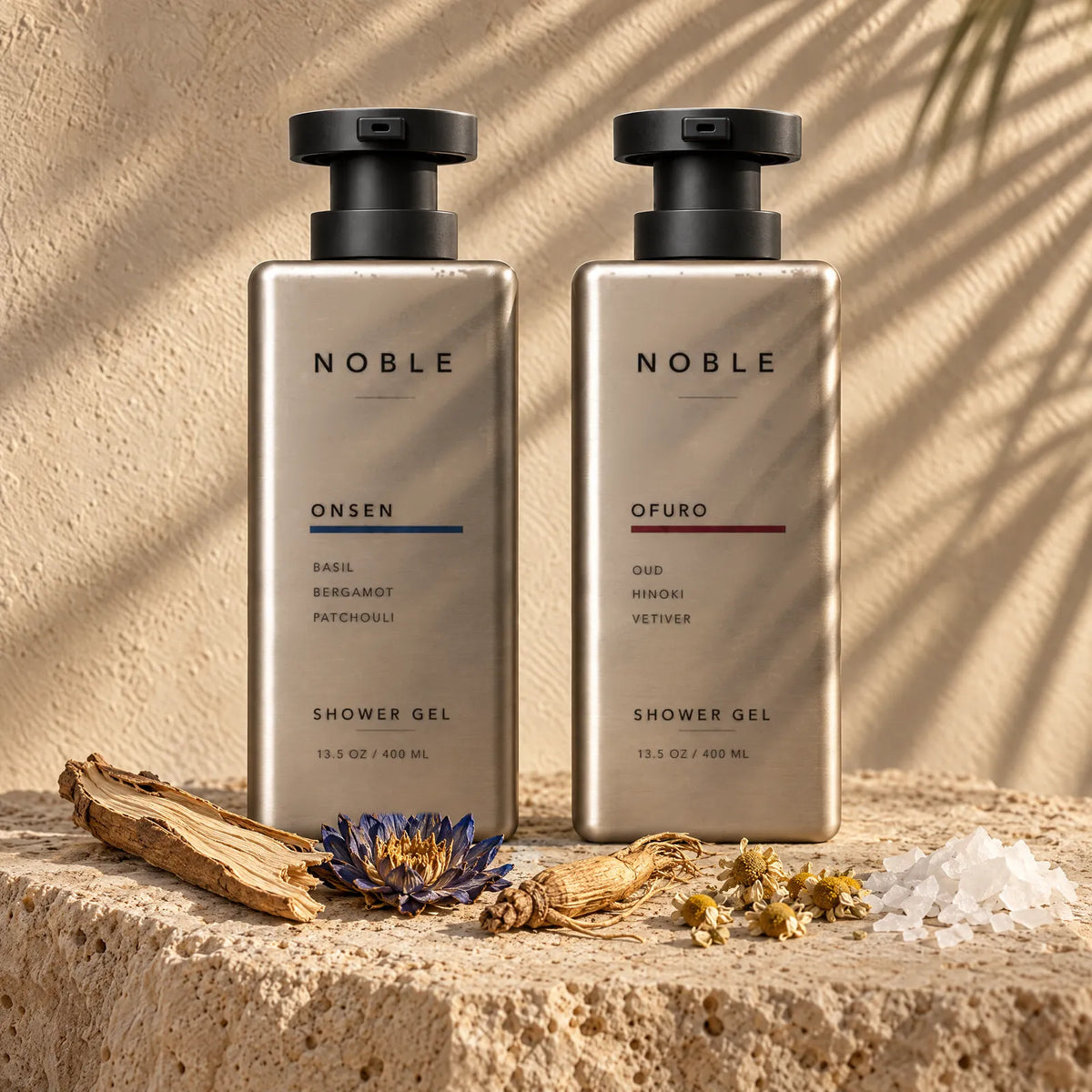 ONSEN and OFURO bottles on sunlit travertine with Tongkat Ali root, blue lotus, ginseng, chamomile and magnesium salt around them