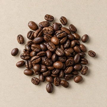 Roasted coffee beans on pale stone