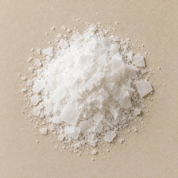 A mound of white magnesium flakes on pale stone