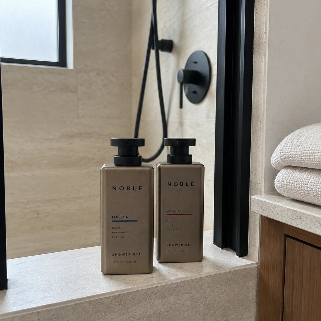 The ONSEN and OFURO metal bottles on a stone shower bench